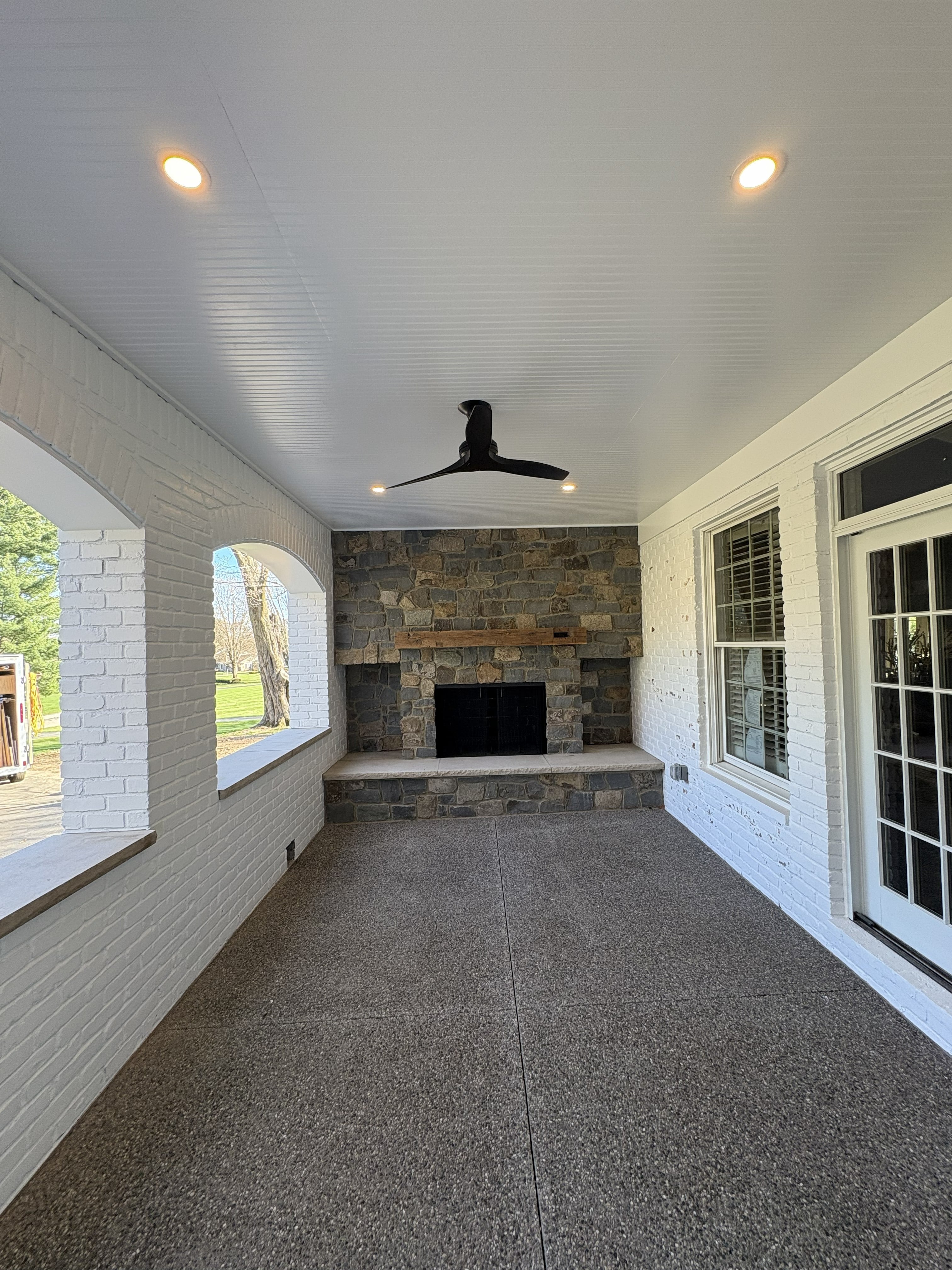 Enclosed Porch Addition : Stacked Stone Fireplace, White Brick & Beadboard Ceiling